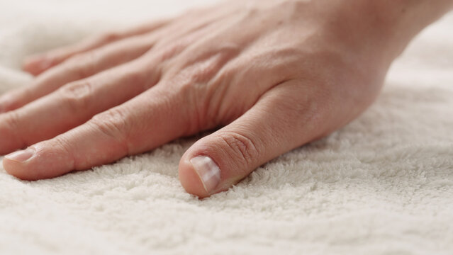 closeup shot of man touching white cotton terry towel