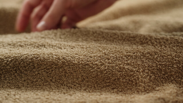 closeup shot of man touching green cotton terry towel