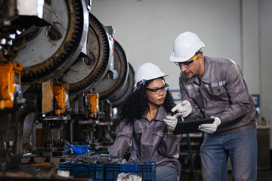 Production Supervisors Inspecting Precision Component with Digital Tablet in Modern Manufacturing Factory