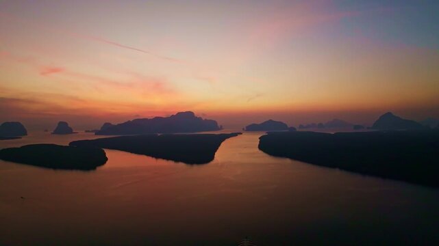 Colorful sunset or sunrise above the sea surface,Aerial view drone fly over open sea,Reflected sun beautiful light of nature on water surface,Sunset over ocean,Sea summer and travel vacation concept