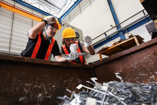 Industrial Workers Sorting Recyclable Manufacturing Scrap for Sustainable Waste Management