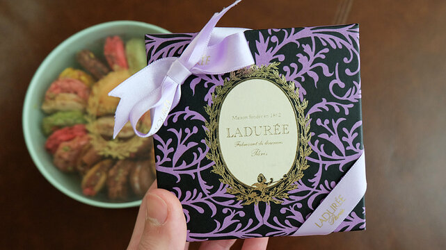 Close up paper box of Laduree- fine French macarons and artisanal pastries store from Paris, France