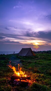 A serene camping scene at sunset with a cozy campfire.