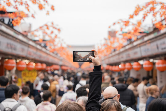 Tourist Photographing Traditional Japanese Market Street