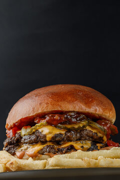 Juicy cheeseburger isolated on a black background.