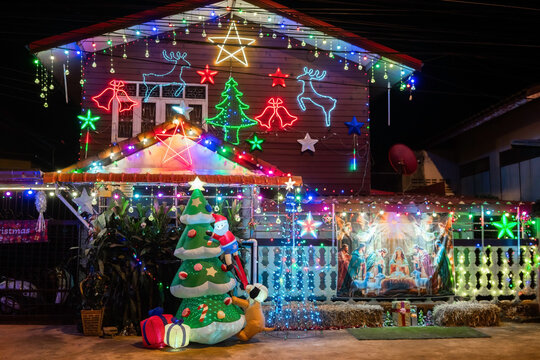 Beautiful house decorated with colorful Christmas lights and festive holiday decorations at night