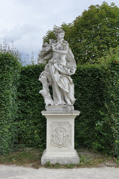 Baroque Statue Playing Flute in the Gardens of Belvedere Palace, Vienna, Austria. 