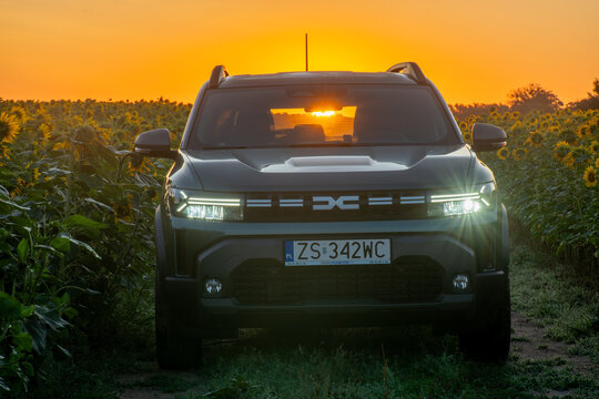 The third-generation Dacia Duster outdoors in a field of blooming sunflowers