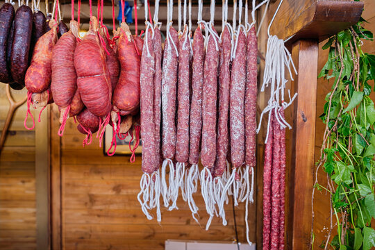 Traditional Catalan artisanal cured meats and sausages hanging at a local market in Catalonia