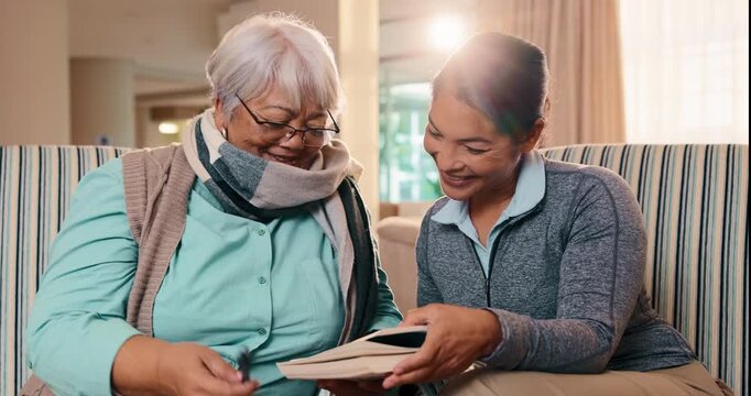 High five, book and nurse with old woman on sofa for crossword puzzle, support and celebration. Alzheimer prevention, strategy game and trivia solution with people in living room of home for answer