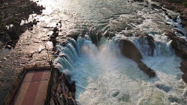 Jabalpur, Madhya Pradesh, India &ndash; April 01, 2026: Cinematic drone footage smoothly flying to the right in a soft orbit, revealing the powerful Dhuandhar Waterfall, rocky gorge, and viewing platform.