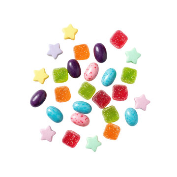 Assorted square gummy bears, glossy jelly beans, and pastel star candies scattered on a white studio surface with soft shadows. concept of sweet confectionery