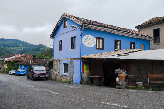 Doriga, Asturias, Spain - May 15, 2025: Traditional bright blue building of Ca Pacita Chigre, a rustic bar and pilgrim hostel along the Camino Primitivo route.