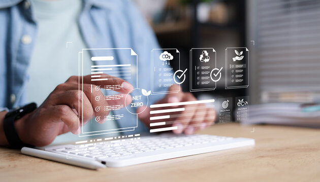 Business professional managing digital ESG compliance documents with net zero, carbon emissions, recycling, and sustainability certification icons. Smart environmental reporting,