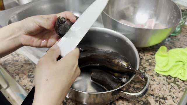 Unrecognizable cook preparing ripe, boiled plantains with a knife for a delicious meal
