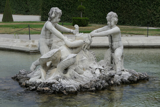 Baroque fountain sculpture with cherubs and fish in the Belvedere Gardens, Vienna, Austria. 