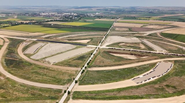 Drone aerial view of the future A7 and A8 turbine motorway interchange near Pașcani, Romania, showcasing large-scale highway construction and transport infrastructure