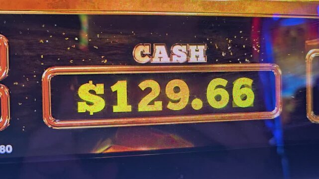 Casino slot machine bonus screen with bright credits total, colorful confetti, yellow and orange lights, glossy display, and arcade style graphics for gambling and jackpot videos.