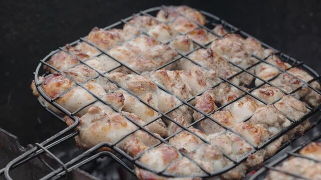 Fresh marinated meat grilling over hot charcoal and open flame