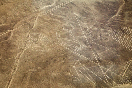 Aerial view of the famous monkey geoglyph of the Nazca Lines etched into the arid desert landscape in Nazca Province, Ica, Peru.