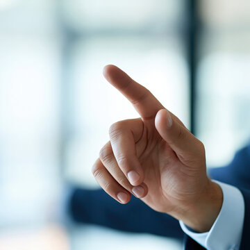Businessman in blue suit pointing finger at virtual screen or touchscreen interface in modern office