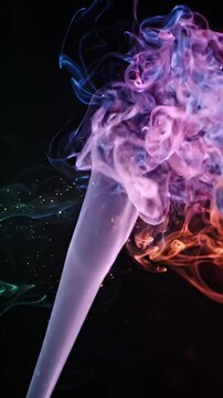 Vibrant Multicolored Smoke Swirls on Dark Background - A dynamic and ethereal wisp of multicolored smoke drifts and swirls across a stark black background.