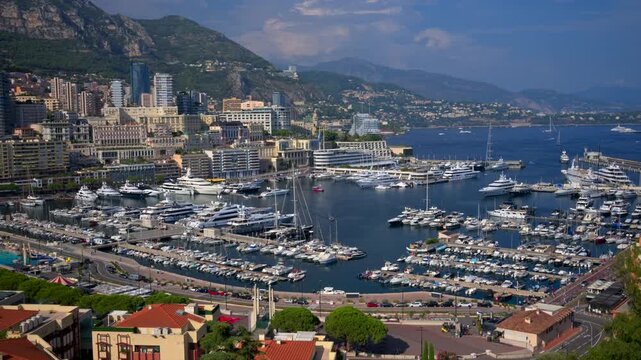 Panoramic high angle view of port hercule harbor with luxury yachts and superyachts moored in monte carlo monaco at sunny summer day.