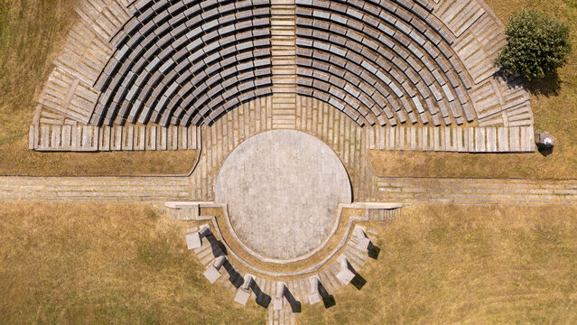 Bubanj memorial park amphitheater capturing an aerial top down view of the circular stone seating and stage