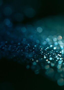Close-up of a dark blue background with small white dots scattered across it. the dots are of different sizes and shapes, creating a bokeh effect.