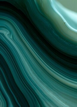 Abstract close-up of a wave-like pattern. the wave appears to be made up of multiple layers of different shades of blue and green, creating a gradient effect.