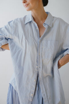 Modern Casual Style Woman In Loose Fit Light Blue Button-Up Shirt And High-Waisted Blue Skirt