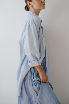 Casual Summer Outfit Featuring Woman In Light Blue Button-Down Linen Shirt Against Minimal Background