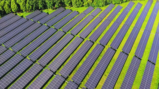 Top down drone view of a solar farm in green countryside
