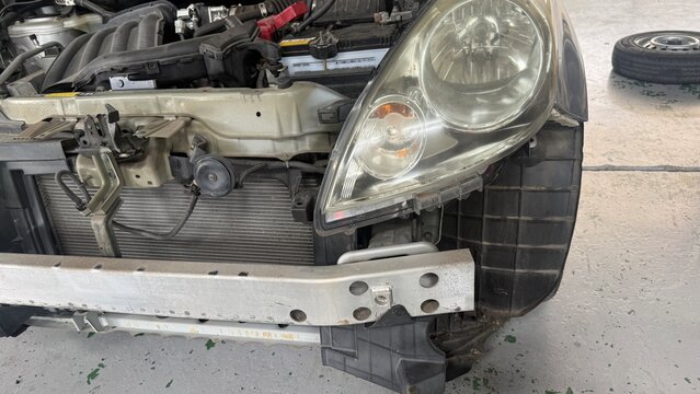 Front-end collision damage with disassembled engine compartment