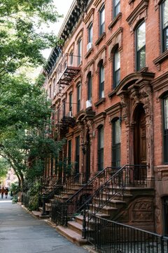 Sunlit brick facades in a classic Brooklyn brownstone neighborhood