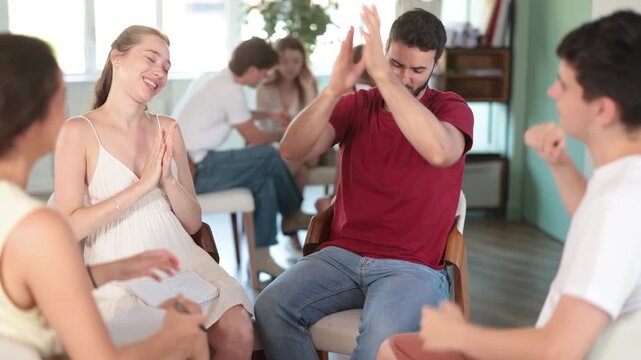 Group of students gathered in circle and rejoiced at victory, exclamations of joy and delight after successful round of intellectual game