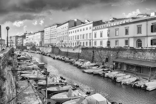 Canals and boats with historic buildings in Livorno, Italy