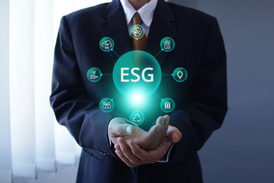 Businessman Holding ESG Hologram and Network for Sustainability Above Hand Palms