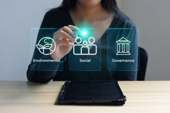Woman Selecting Social Option from ESG Hologram with Stylus on Tablet