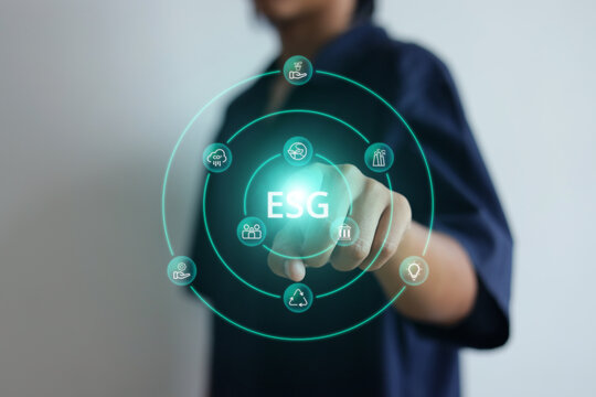 Person Pressing Circular Digital ESG Screen Hologram with Finger Against White Background