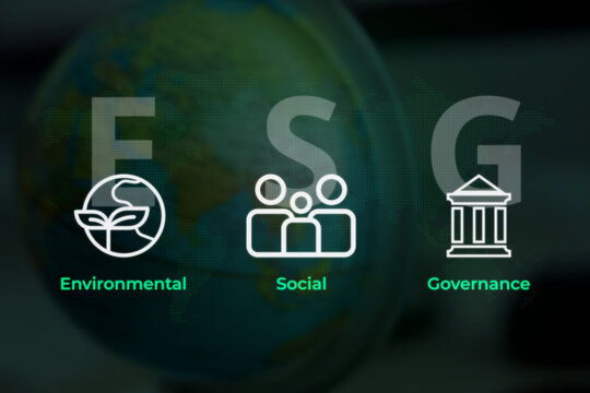 ESG Typography Displaying Earth People and Bank Symbols Against Blurred Planet Globe Background