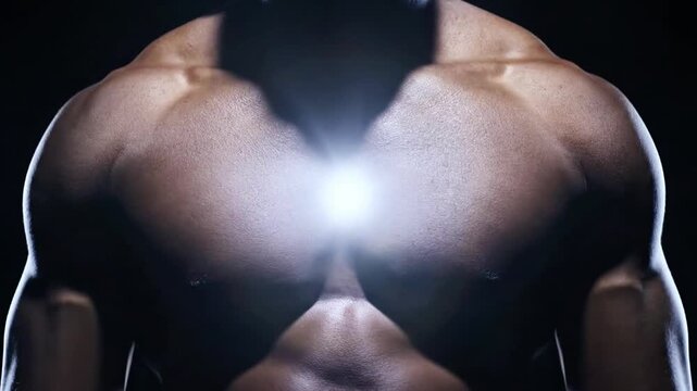 Muscular male torso with glowing light in chest center