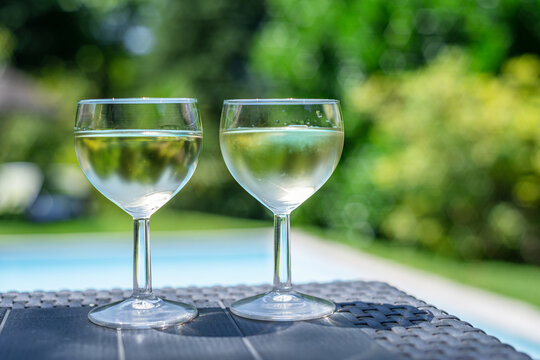 Two glasses of white wine on outdoor table