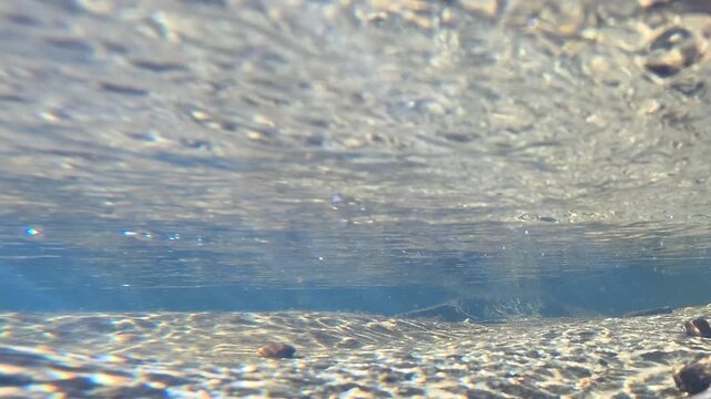 Underwater View of Sunlight Refraction on Freshwater Creek Bed