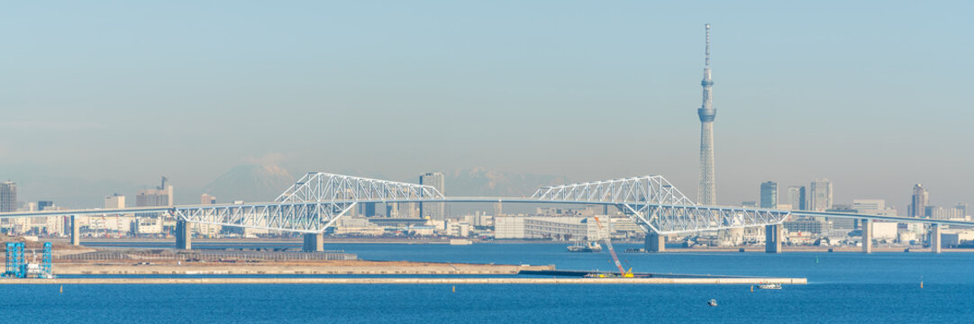 Panoramic view of Tokyo Gate Bridge a truss cantilever bridge across Tokyo Bay and city skyline in background in Tokyo Japan