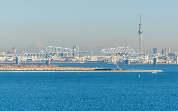 Scenic morning panorama of Tokyo Gate Bridge a truss cantilever bridge across Tokyo Bay and city skyline in background in Tokyo Japan