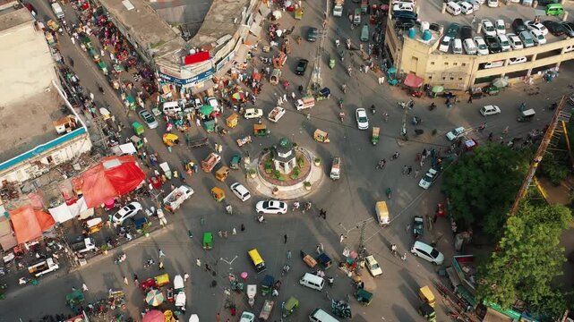 Bird's Eye View of Crowded Street Roundabout with Cars Rickshaws and Vendors in Pakistan