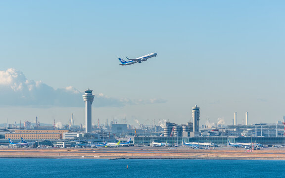 Tokyo Haneda airport and control tower with ANA airline plane taking off in Tokyo Japan