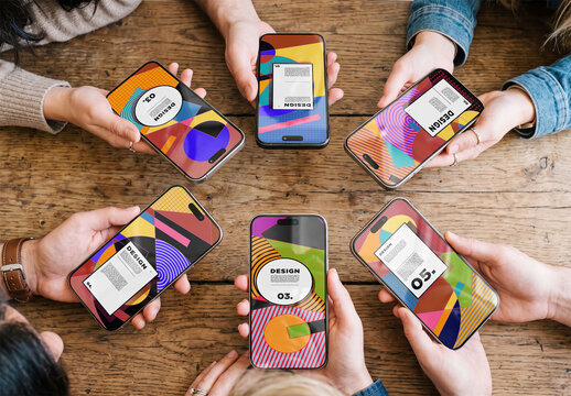 Mockup of People sit around a wooden table holding their smartphones. Their hands show different devices with black screens with real reflections