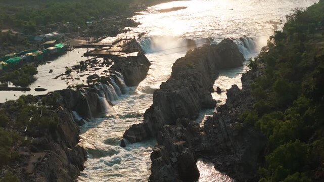 Jabalpur, Madhya Pradesh, India &ndash; April 01, 2026: Cinematic drone footage flying forward to reveal the powerful Dhuandhar Waterfall on the Narmada River at Bhedaghat with a rocky gorge.